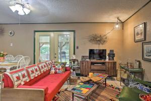 a living room with a couch and a tv at Unique Vintage Hideaway Less Than 6 Miles to Lackland AFB! in San Antonio