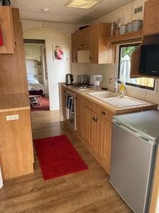 a small kitchen with a sink and a dishwasher at Tummel 2 in Forfar