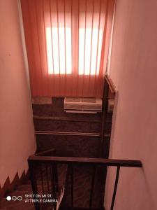 a staircase with a window with a dvd player on it at apartmani mejdan in Tuzla