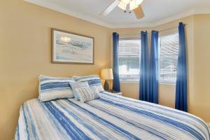 - une chambre avec un lit doté de rideaux bleus dans l'établissement Seascape 2305 Condo, à Galveston