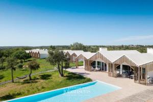 an image of a villa with a swimming pool at Sobreiras Alentejo Country Hotel in Santa Margarida da Serra