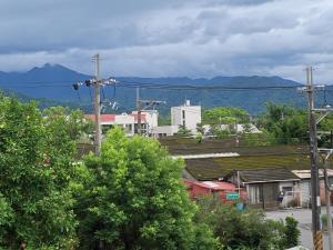 Blick auf eine Stadt mit Bergen im Hintergrund in der Unterkunft Red Rose B&B漫楓宿民宿 桃園市民宿110號 in Longtan