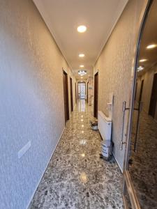 a hallway of a bathroom with a toilet in it at Hotel Lotus in Akhaltsikhe