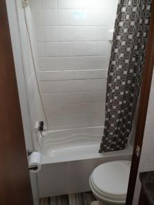 a bathroom with a toilet and a shower curtain at 2017 Camper located at the St. George RV Park! in St. George