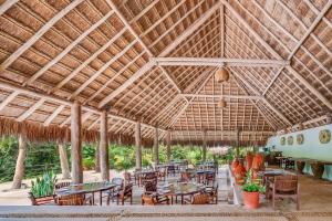 a large pavilion with tables and chairs and an airplane at The Explorean Kohunlich - All Inclusive in Ruinas Kohunl&iacute;ch
