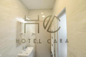 a bathroom with a sign for a hotel clara at Hotel Cara 28 in Skopje