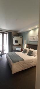 a bedroom with a large bed with a large window at Jacona 365 in Palermo