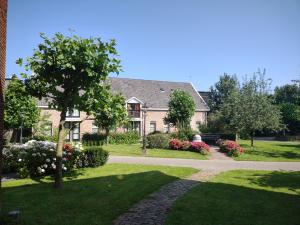una casa con una pasarela frente a un patio en B&B Landgoed Rijckholt, en Geersdijk