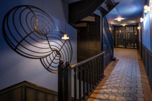 a hallway with a staircase with a spiral painting on the wall at HAB Hotel Bogotá in Bogotá