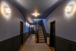 a hallway with a staircase with blue walls and lights at HAB Hotel Bogotá in Bogotá