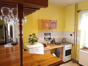a kitchen with yellow walls and a stove top oven at Čavoj Guest House in Čavoj