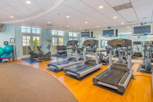 a gym with treadmills and ellipticals in a room at Sunset Island - 22 Island Edge in Ocean City