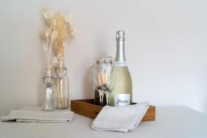 a bottle of wine sitting on a table with other bottles at Stowaways Loft in Whitby