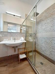 a bathroom with a sink and a shower at La Casa in Piazza in Massa Lubrense