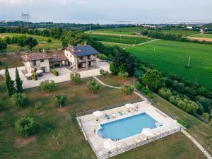 an aerial view of a house with a swimming pool at Il Casale Lonato - by Host4U in Lonato del Garda
