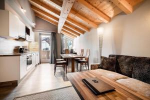 a kitchen and living room with a couch and a table at Ferienvilla Bergfried in Tux