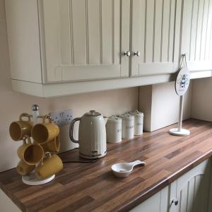 a kitchen counter with a tea kettle and cups on it at Mountain View Aberavon Beach, Afan Valley & Margam Park, South Wales in Port Talbot