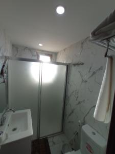 a bathroom with a shower and a toilet and a sink at Golden Rose Hotel in Nablus +54 photos