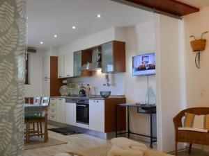 a kitchen with white cabinets and a stove top oven at Apartment Open Space with Patio Lety by Interhome in Malvaglia