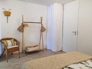 a bedroom with a bed and a chair and a window at Apartment Open Space with Patio Lety by Interhome in Malvaglia