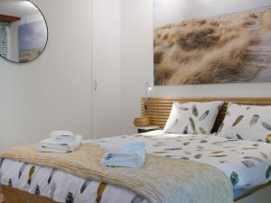 a bedroom with a bed with two towels on it at Apartment Open Space with Patio Lety by Interhome in Malvaglia +22 photos