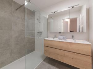 a bathroom with a sink and a shower at Apartment Medano with balcony by Interhome in Bredene