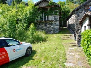 a car parked in front of a house at Chalet Pimpisnino by Interhome in Brissago