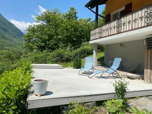 two blue chairs sitting on a wooden deck at Holiday Home Motta by Interhome in Aquino