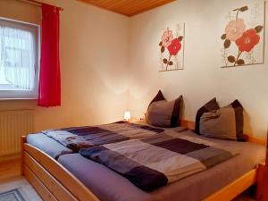 a bedroom with a large bed with a red curtain at Holiday Home Ferienpark Himmelberg-8 by Interhome in Thalfang