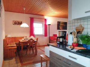 a kitchen with a table and a dining room at Holiday Home Ferienpark Himmelberg-8 by Interhome in Thalfang