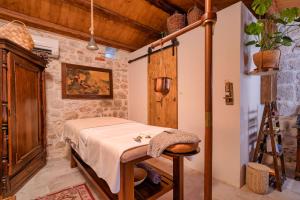 a bedroom with a bed in a room with a tripod at Town House Rosario in Stari Grad