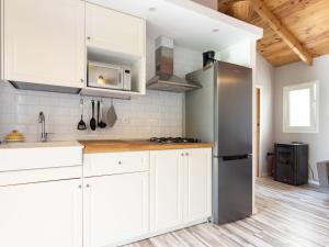 a kitchen with white cabinets and a stainless steel refrigerator at Holiday Home Jorge by Interhome in Zamorano