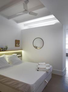 a bedroom with a bed with a mirror and a ceiling fan at Best House Best Place in Barcelona