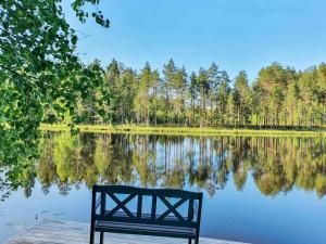 a bench sitting on a dock next to a lake at Holiday Home Polkurinne by Interhome in Saarijärvi