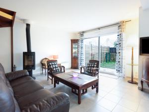 a living room with a couch and a table at Holiday Home Les Jardins du Levant by Interhome in Quiberon