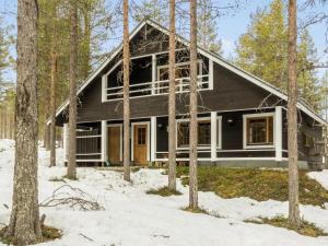 a house in the woods in the snow at Holiday Home Levilla by Interhome in Sirkka
