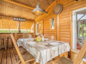 Un comedor con una gran mesa y sillas de madera. en Chalet Landais by Interhome, en Saubion
