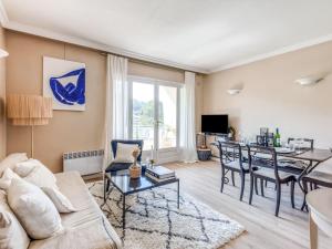 a living room with a couch and a table at Apartment Le Val Riant by Interhome in Cannes