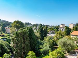 a view of a park with trees and buildings at Apartment Le Val Riant by Interhome in Cannes