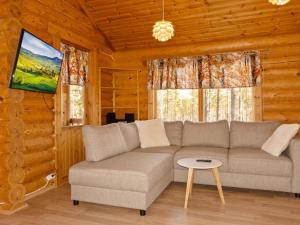 a living room with a couch and a table at Holiday Home Hirsikoto by Interhome in Saariselka