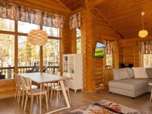 a dining room and living room with a table and chairs at Holiday Home Hirsikoto by Interhome in Saariselka