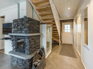 a living room with a stone fireplace in a house at Holiday Home Taruilevi 8 h3 by Interhome in Levi