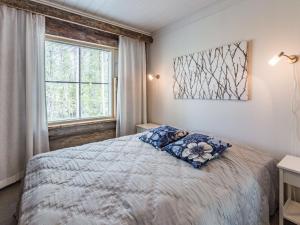 a bedroom with a bed and a window at Holiday Home Taruilevi 8 h3 by Interhome in Levi +13 photos