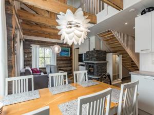 a dining room and living room with a table and chairs at Holiday Home Taruilevi 8 h3 by Interhome in Levi