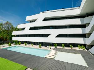 an external view of a building with a swimming pool at Apartment Kenese by Interhome in Balatonszemes