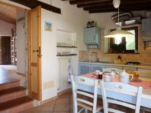 a kitchen with a table and chairs and a sink at Holiday Home Casa Poesia by Interhome in Boccheggiano