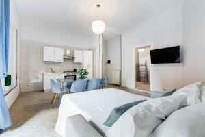 a white living room with a white bed and a kitchen at Trevi Fountain - NEW! - Your Italian Holidays in Rome +102 photos