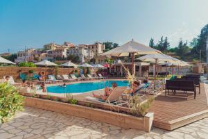 a group of people sitting in chairs by a pool at Nuevo Vista in Kavos