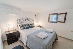 A bed or beds in a room at Seafront House in Andros Town by Explore Andros