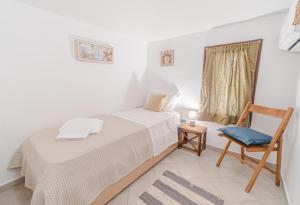 A bed or beds in a room at Seafront House in Andros Town by Explore Andros